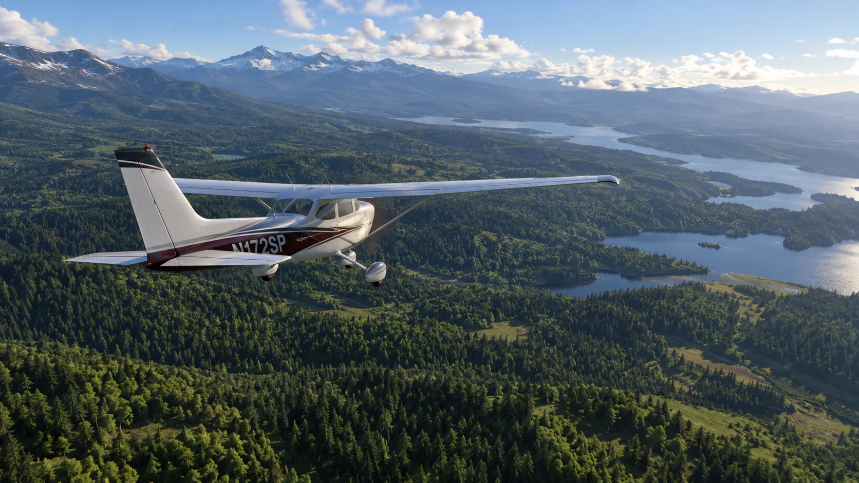 A Cessna 172 flying over forest, lakes and snow-capped mountains